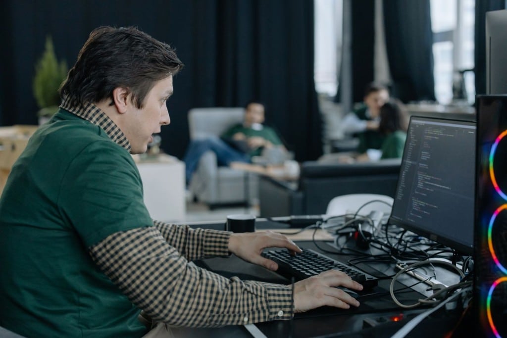 Cuánto gana un ingeniero informático en España en 2026 Profesional de informática programando en un ordenador en la oficina