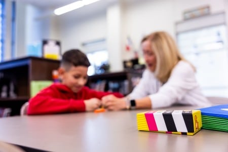 Psicopedagogía infantil: cuándo acudir y qué se trabaja Profesora y alumno realizan una actividad de aprendizaje en el aula
